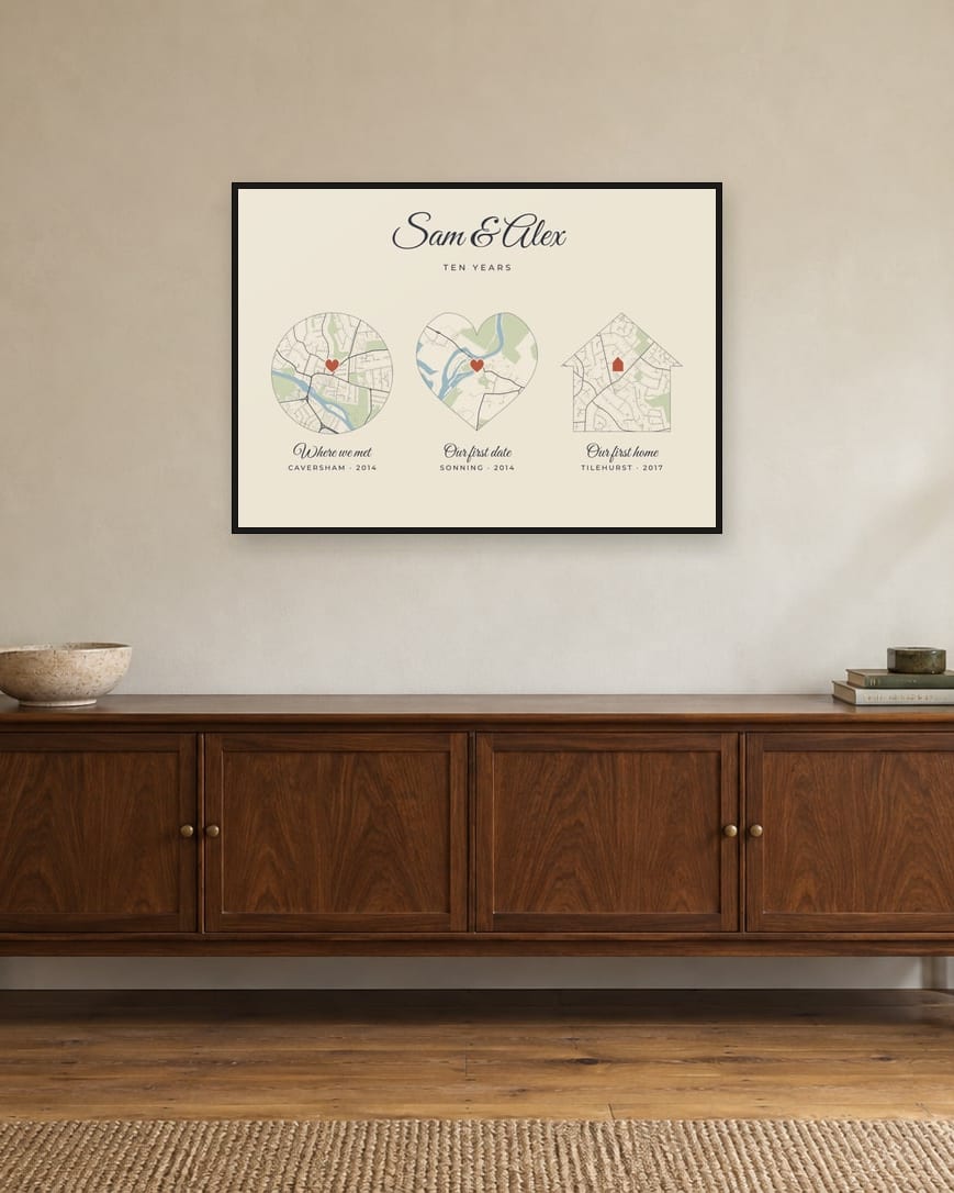 A story map with Caversham, Sonning and Tilehurst in a circle, a heart and a house, in a black frame above a sideboard