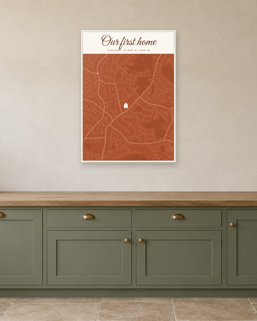 A street map of Tilehurst titled Our first home, with a house marking the spot, in a white frame in a kitchen