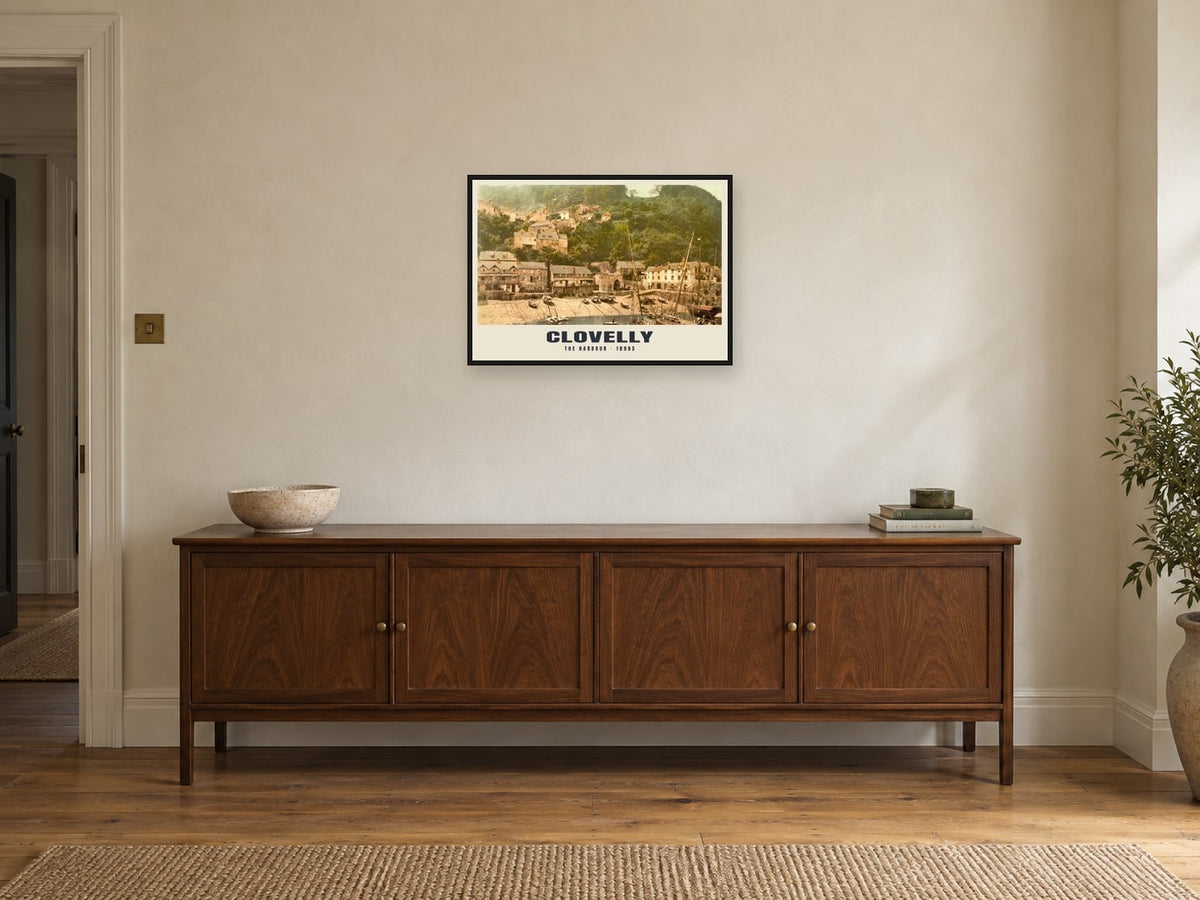 The Harbour, Clovelly, 1890s Heritage Print at A2, in a black frame, above a sideboard