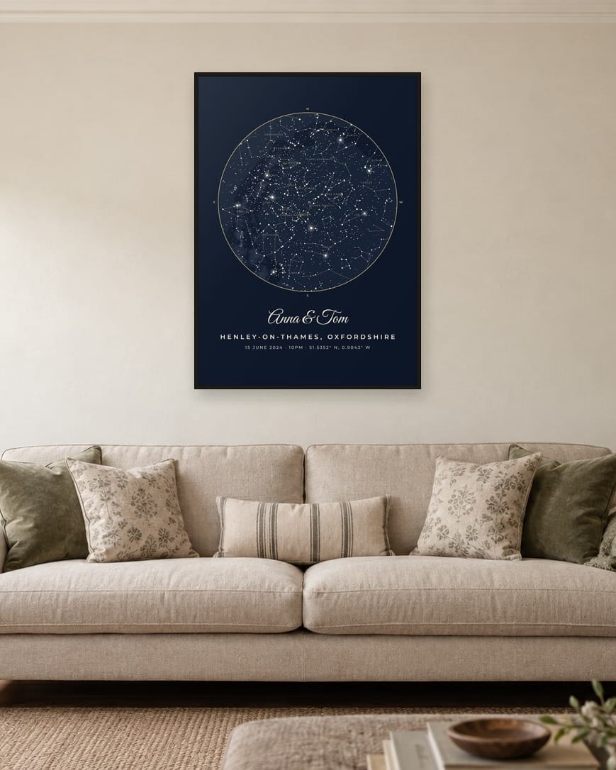 A star map titled Anna & Tom: the sky over Henley-on-Thames at 10pm on 15 June 2024, in a black frame above a sofa